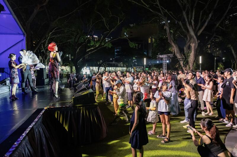 Crowd gathered at an outdoor night stage